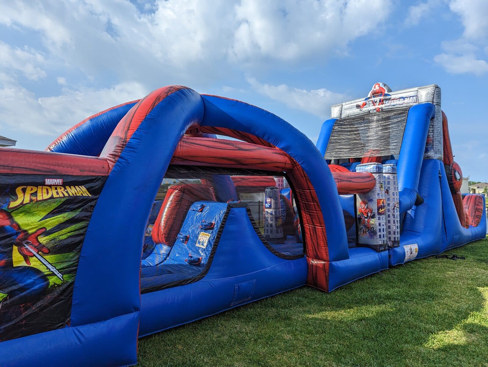 Spider-Man inflatable obstacle course set up in a Johnson County backyard